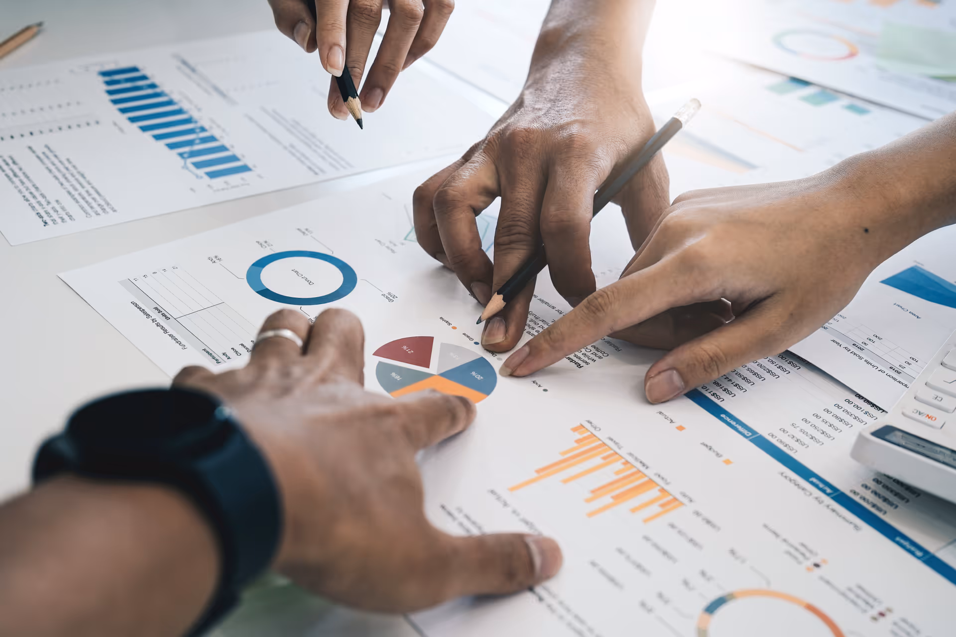 Team analyzing financial charts and data sheets during a collaborative review