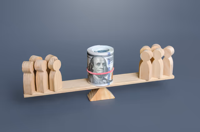 Wooden figures on a balance board with money in center, representing pay equity challenges and wage fairness issues