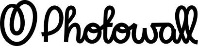 Photowall logo in cursive script lettering on dark background