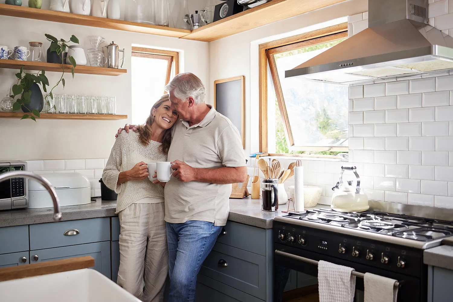 Mature couple smiling in kitchen