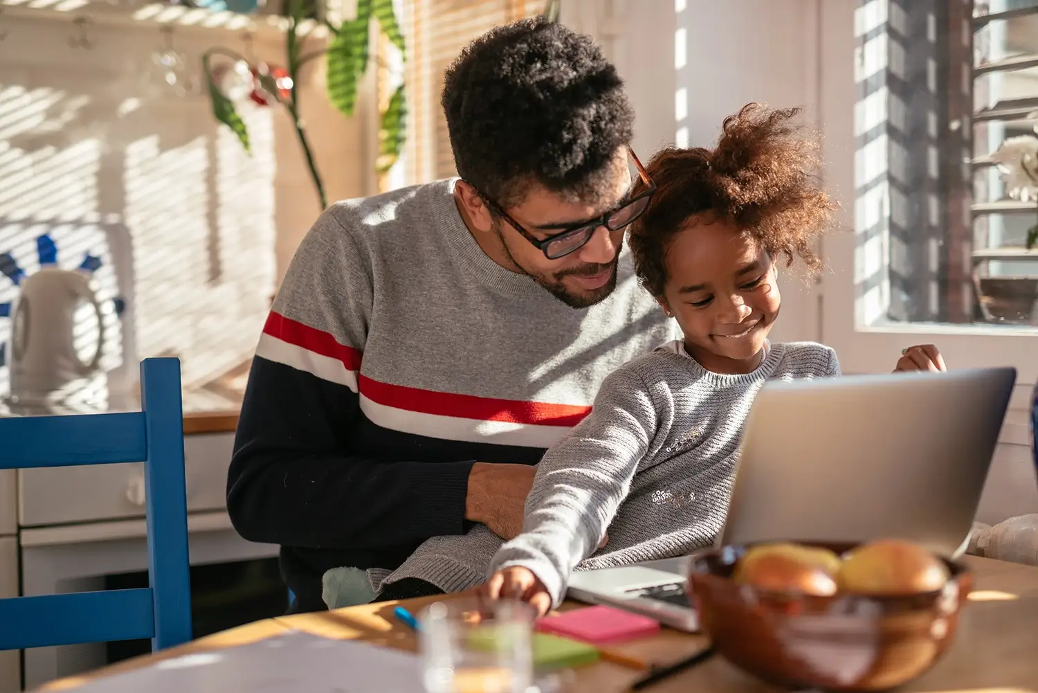 Dad and daughter on laptop