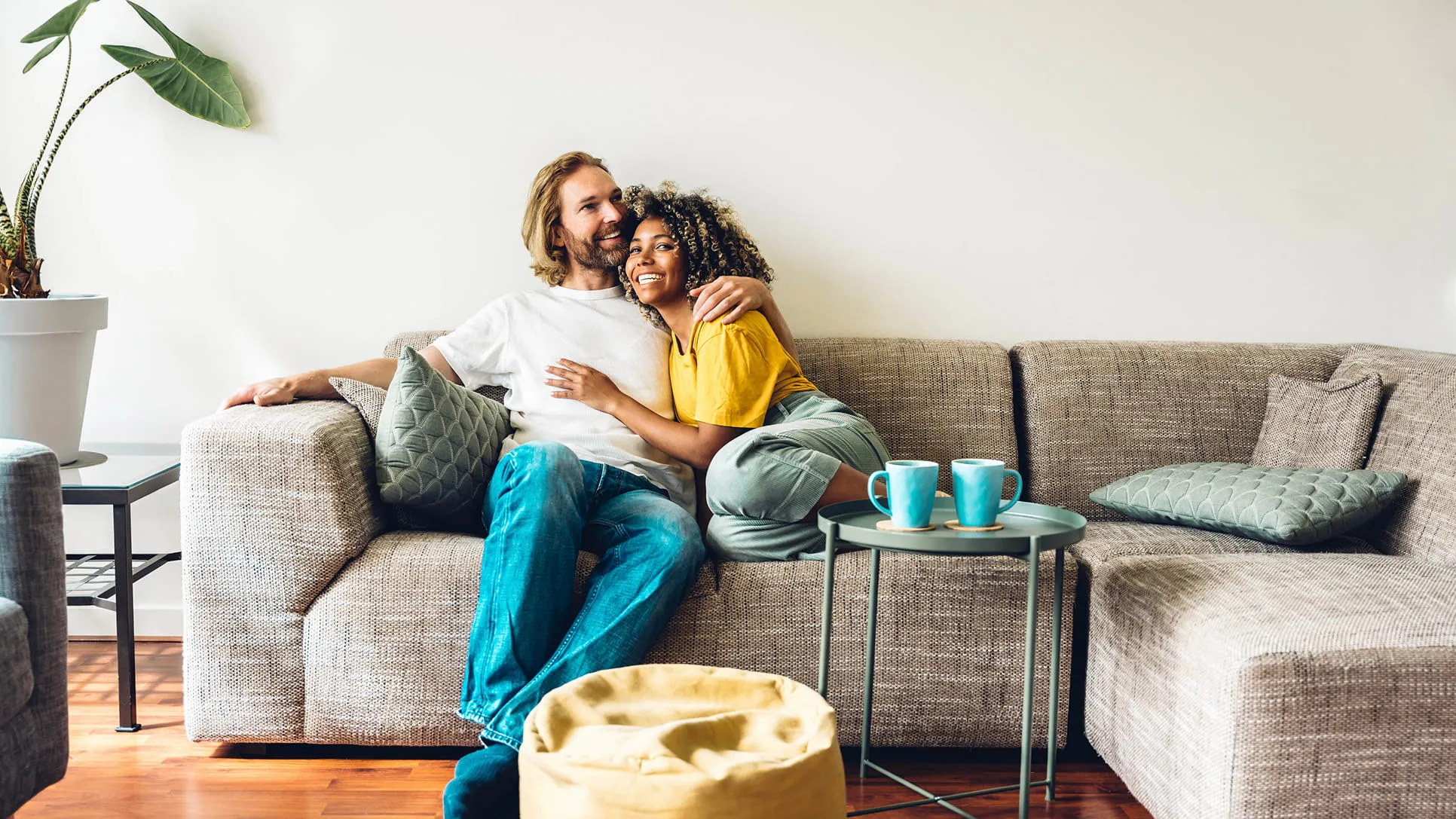 Happy couple relaxing on sofa at home