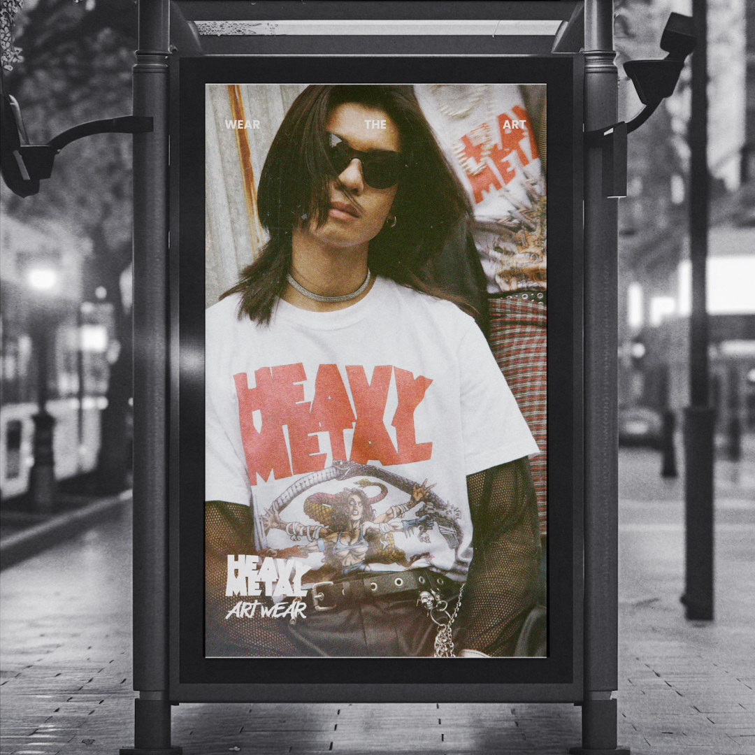 Advertisement featuring a woman wearing sunglasses and a white T-shirt with bold red text 'HEAVY METAL' and graphic art, promoting Heavy Metal Art Wear.
