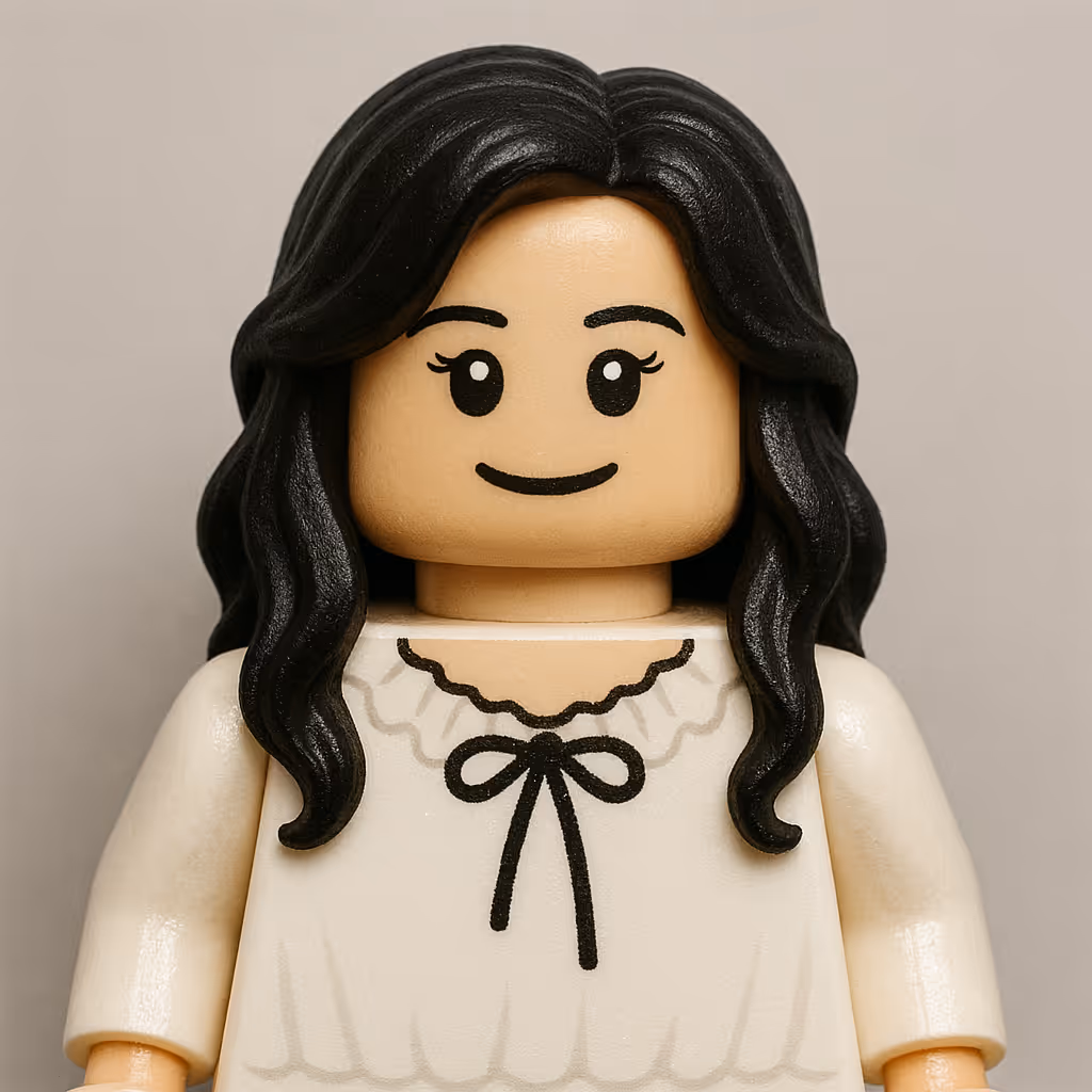 LEGO minifigure with long black wavy hair and a white top with a black bow design.