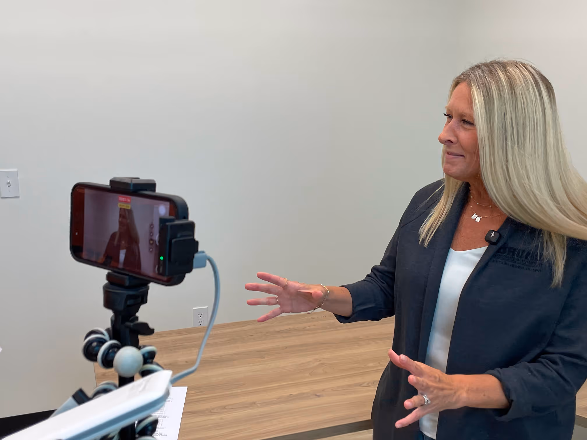 Woman smiling on camera while being filmed