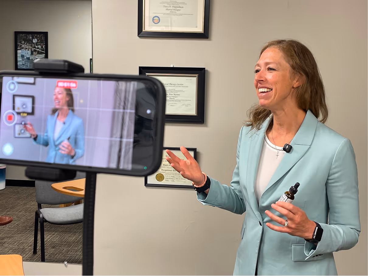 Woman smiling on camera while being filmed