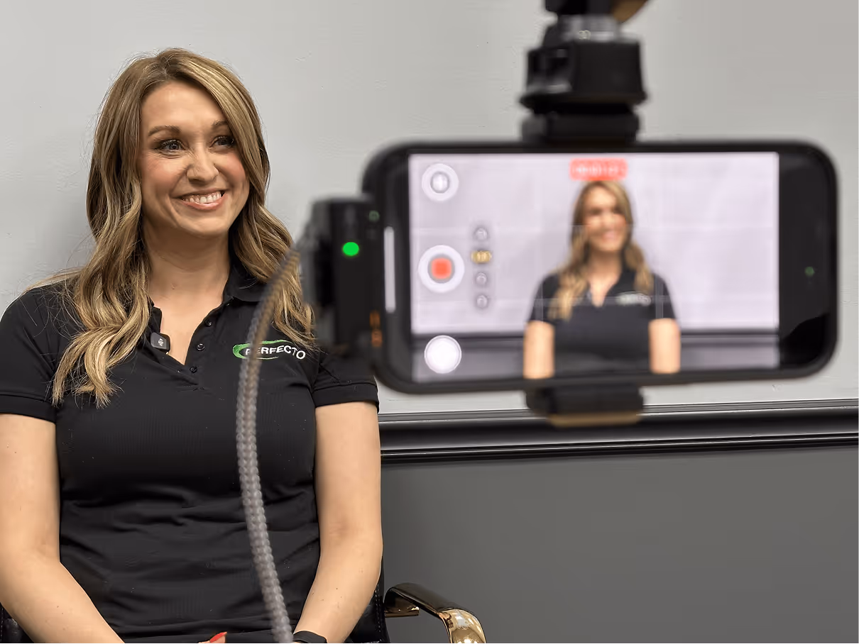 Woman smiling on camera while being filmed