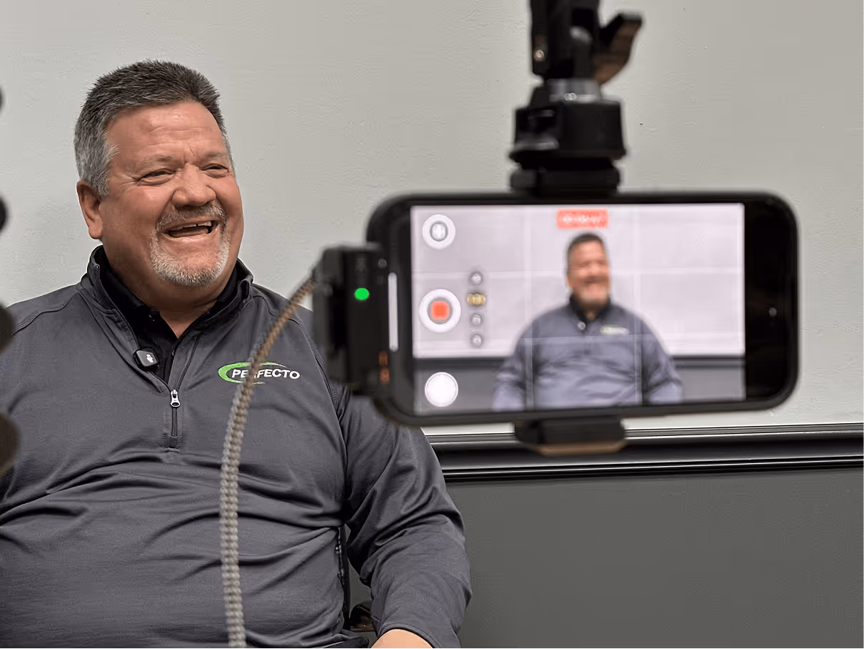 Man smiling on camera while being filmed