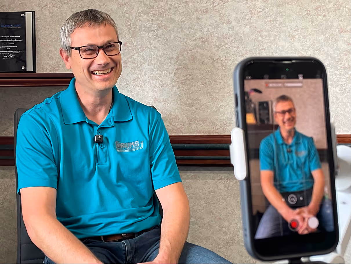 Man smiling on camera while being filmed