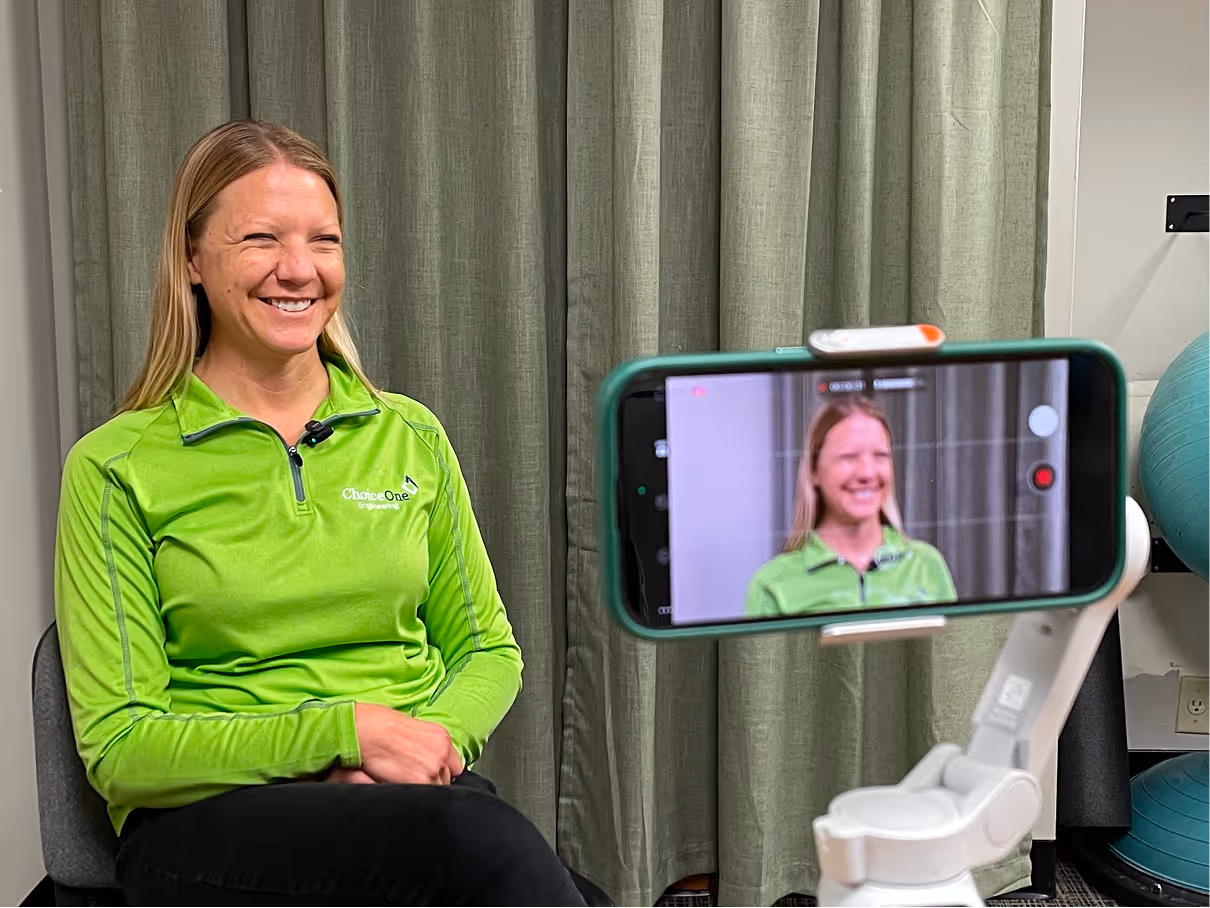 Woman smiling on camera while being filmed