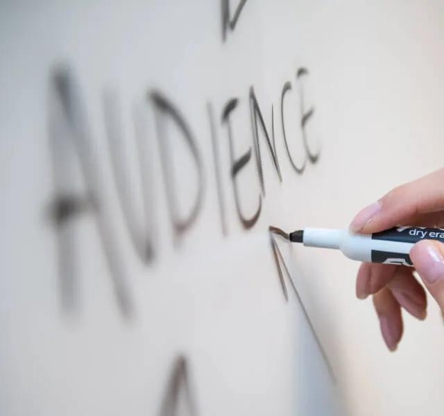 a person writing on a wall with a marker