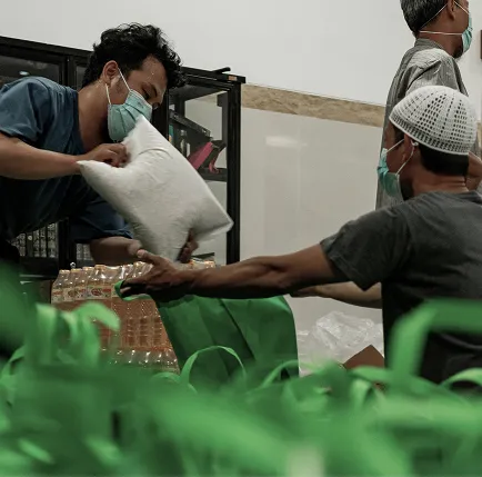 View from an airplane window showing the wing, clear sky, and distant landscape below.