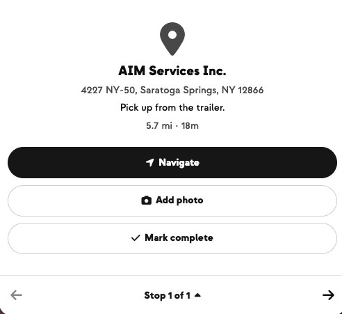 Driver stop view for AIM Services Inc. — navigate, add a proof-of-delivery photo, and mark the stop complete