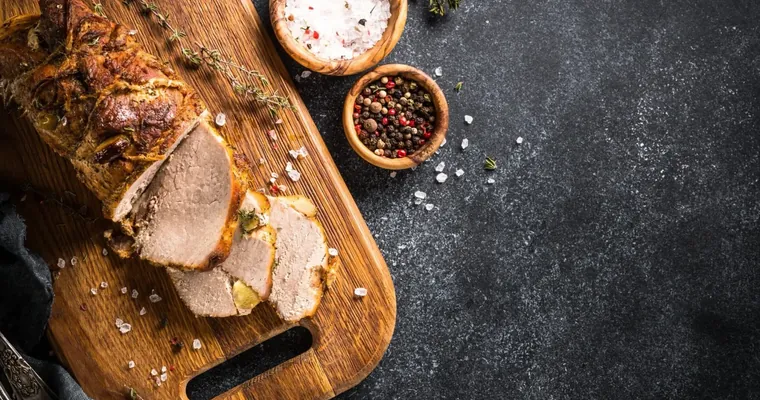 A roast from Harmony Hills Farmstead sliced on a board