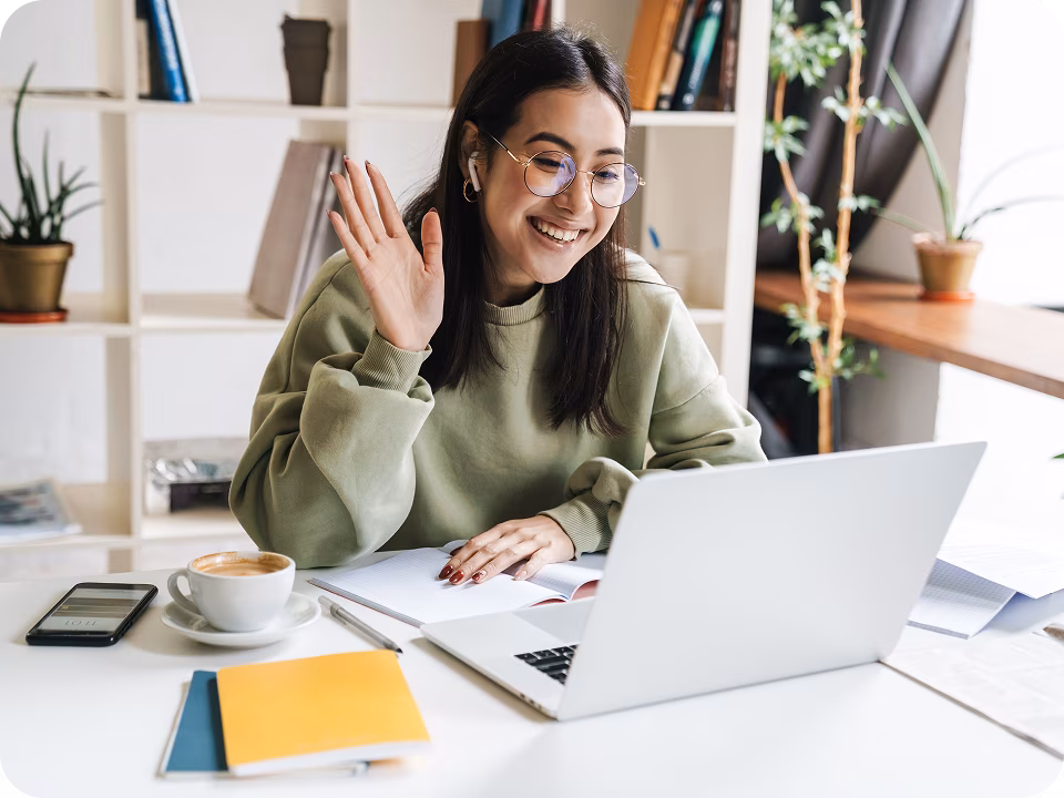A woman waving during her first virtual therapy session in Canada, showing how to start therapy with a licensed therapist online therapy session.


