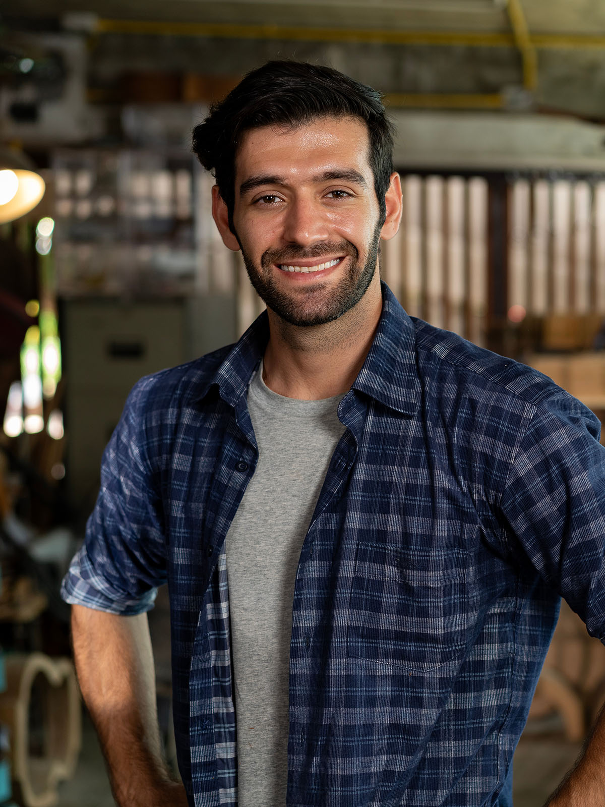 Smiling contractor standing in his workshop