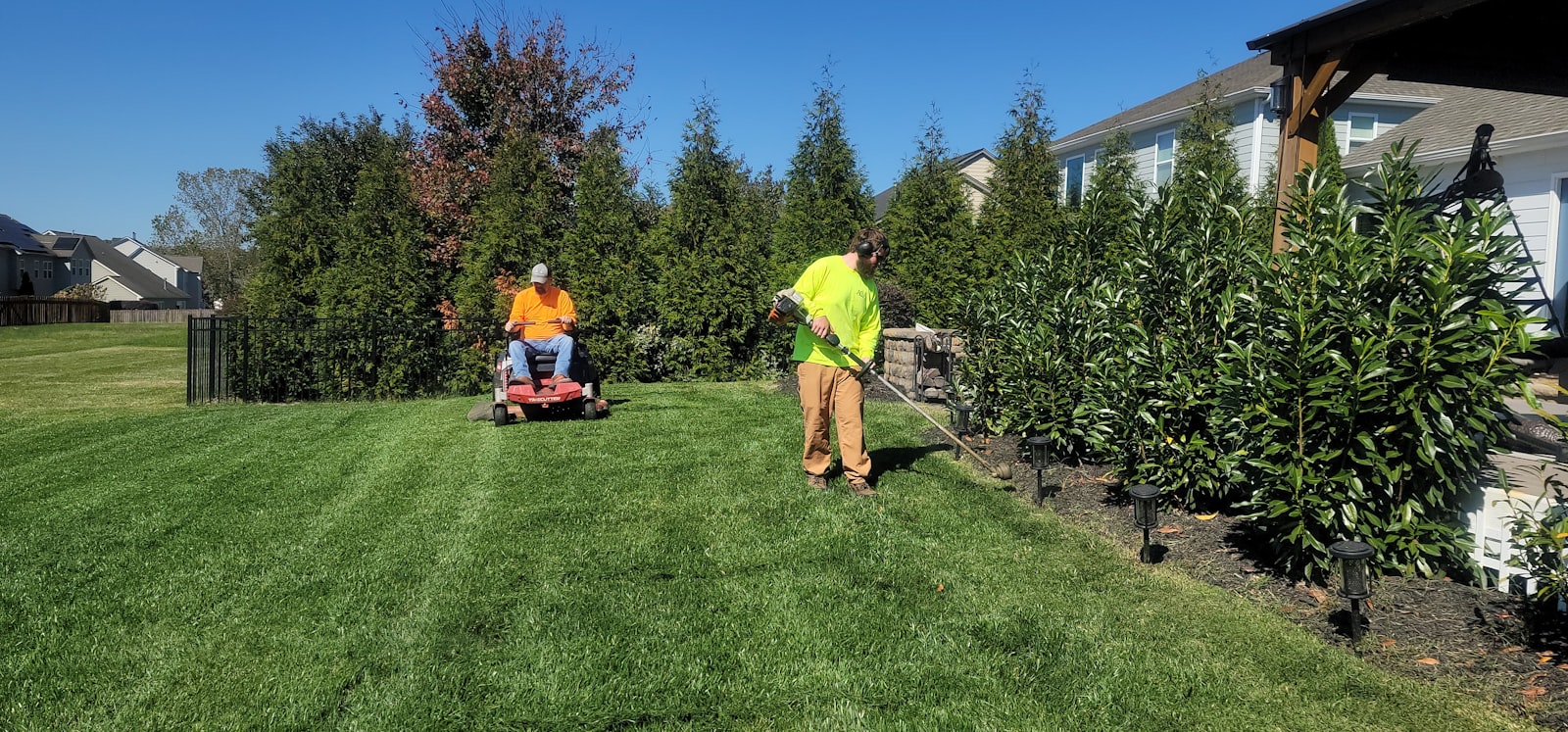 Landscaper mowing a residential lawn in Sevierville