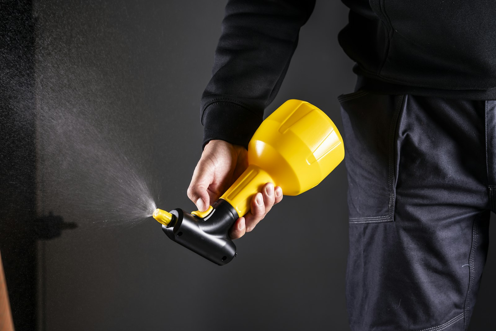 Pest control technician holding a sprayer