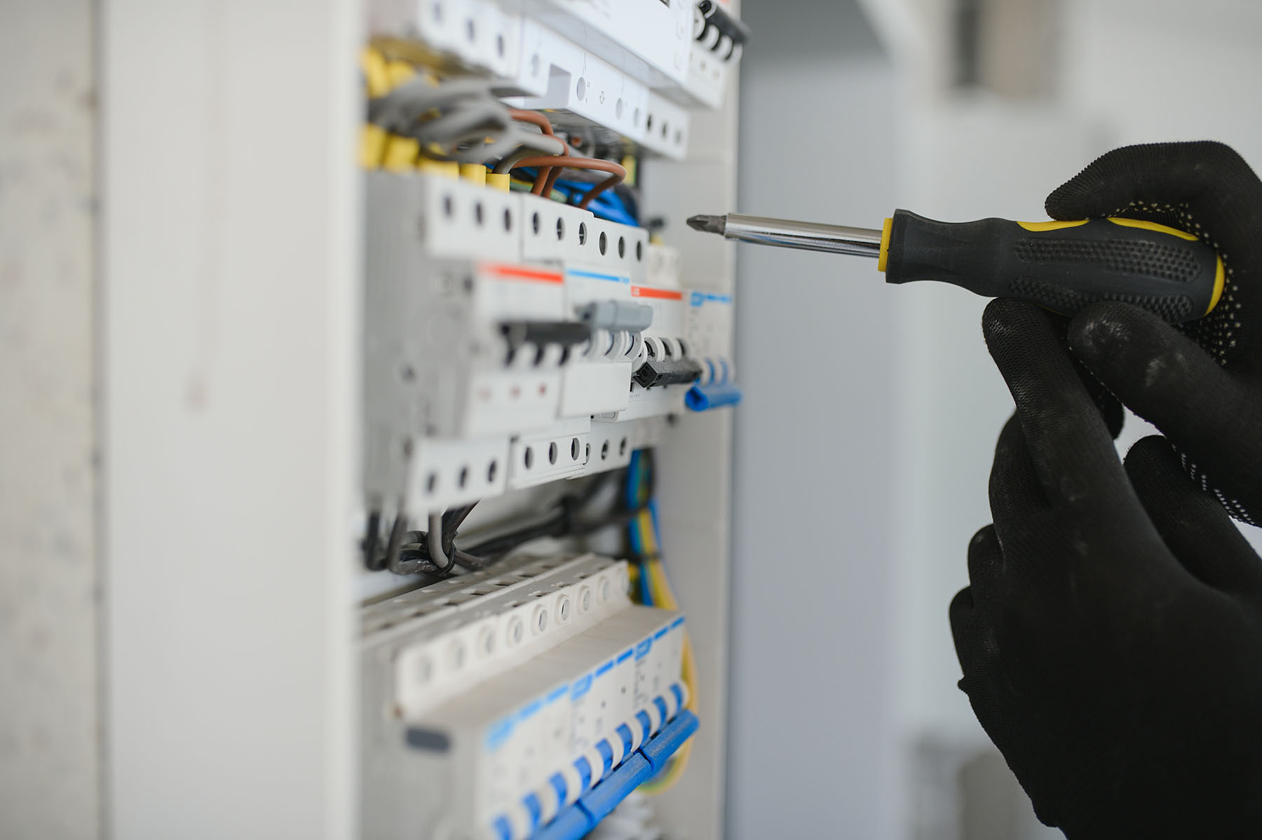 Electrician servicing a circuit breaker panel in Morristown, Tennessee