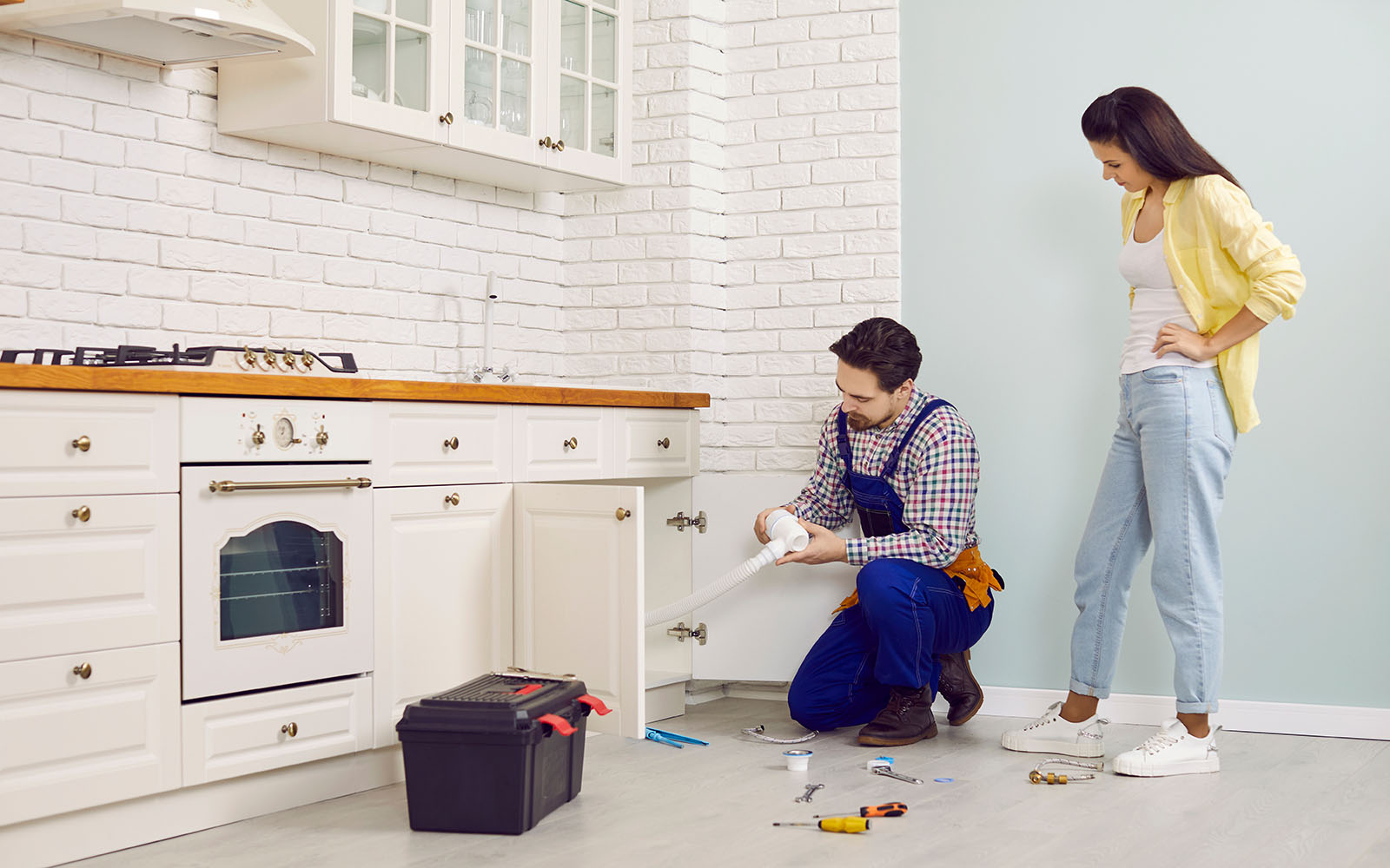 Plumber repairing a sink drain at a home in Cleveland, Tennessee