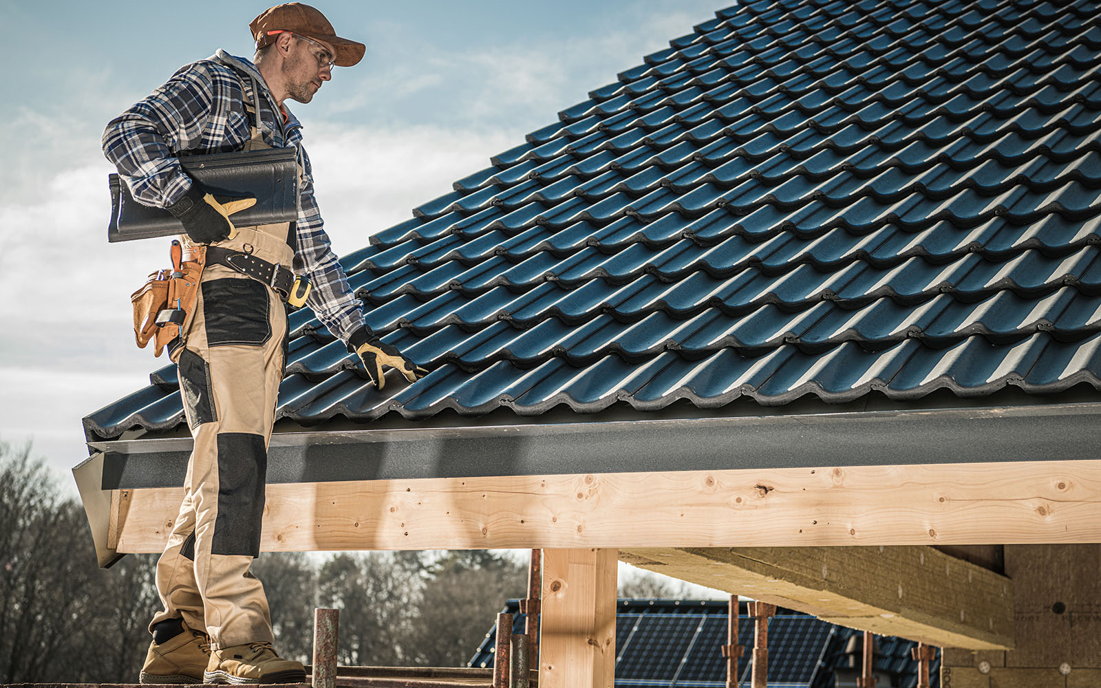 Roofing contractor installing tile roofing on a home in Morristown, Tennessee
