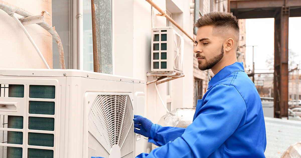 Technician installing an outdoor air conditioning unit