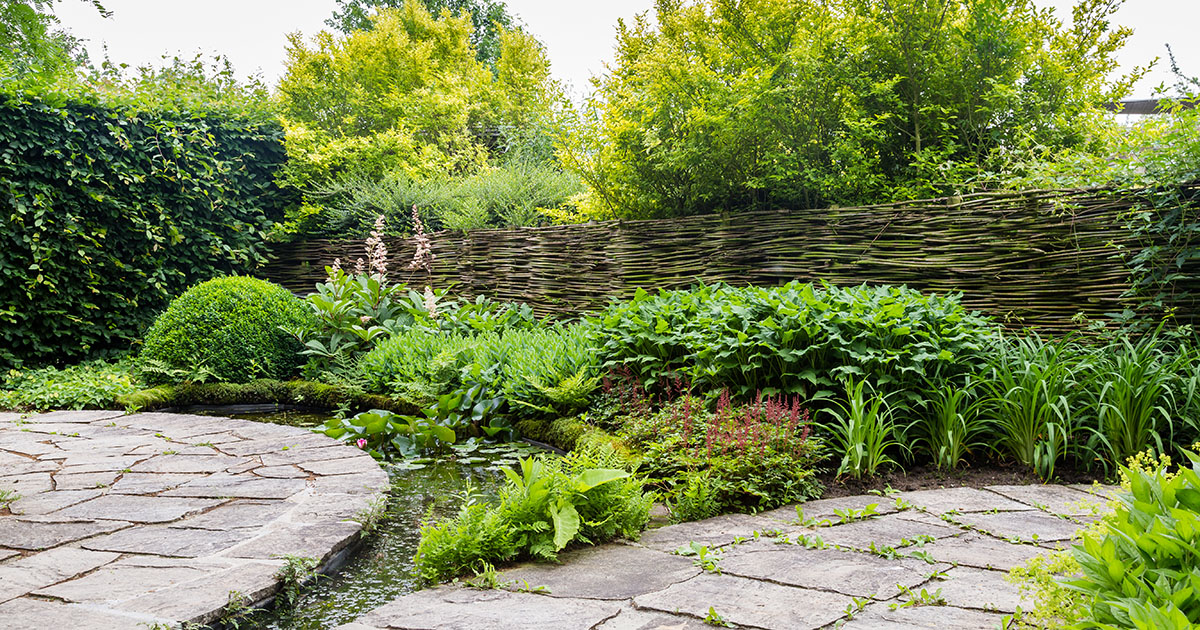 Designed garden with flagstone and water feature — positioning for Lenoir City landscapers