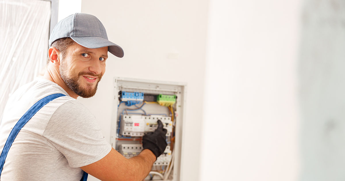 Electrician working at a residential breaker panel