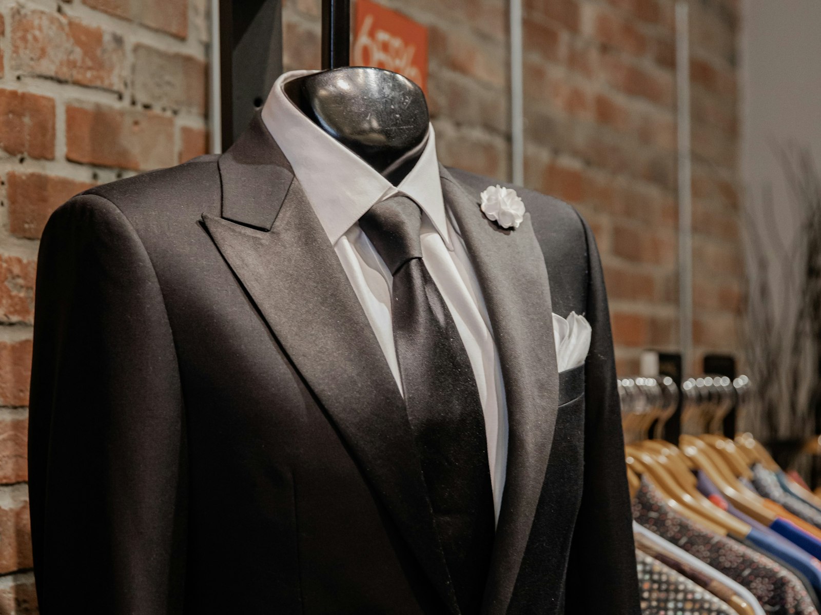 Tailored black suit on a display mannequin in a formalwear shop