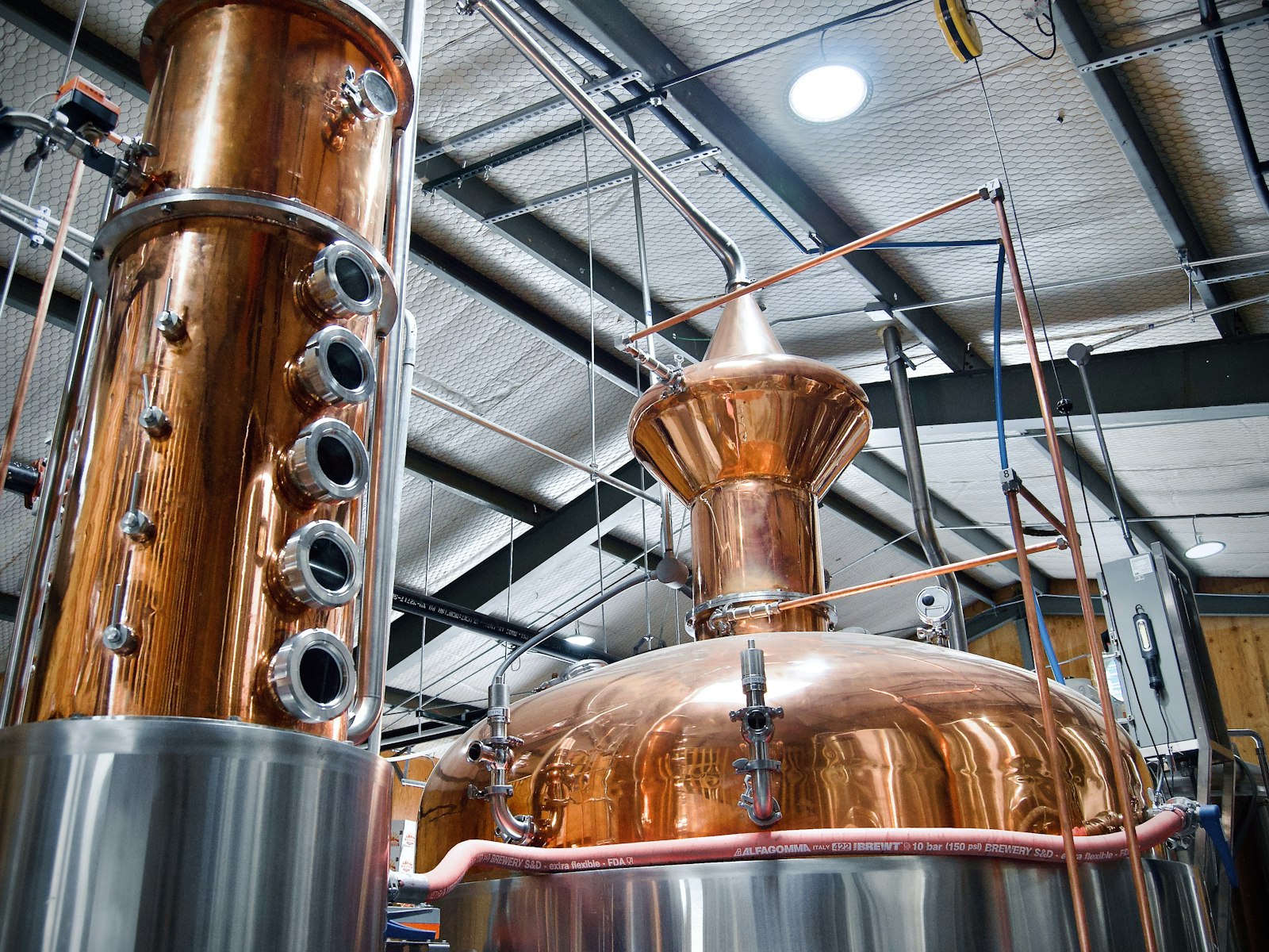 Copper pot still and column inside a craft distillery