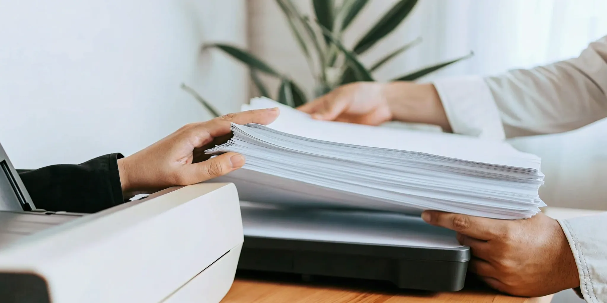 Applying for a loan with a large stack of paperwork instead of online.