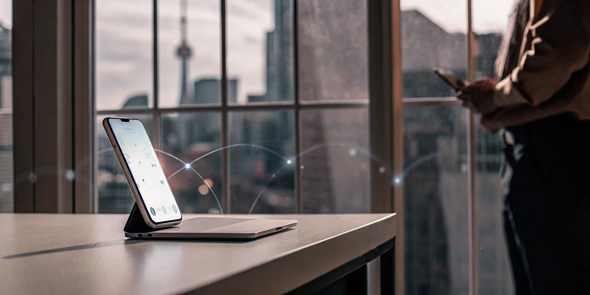 Laptop and smartphone displaying secure financial data connections for Open Banking in Canada.