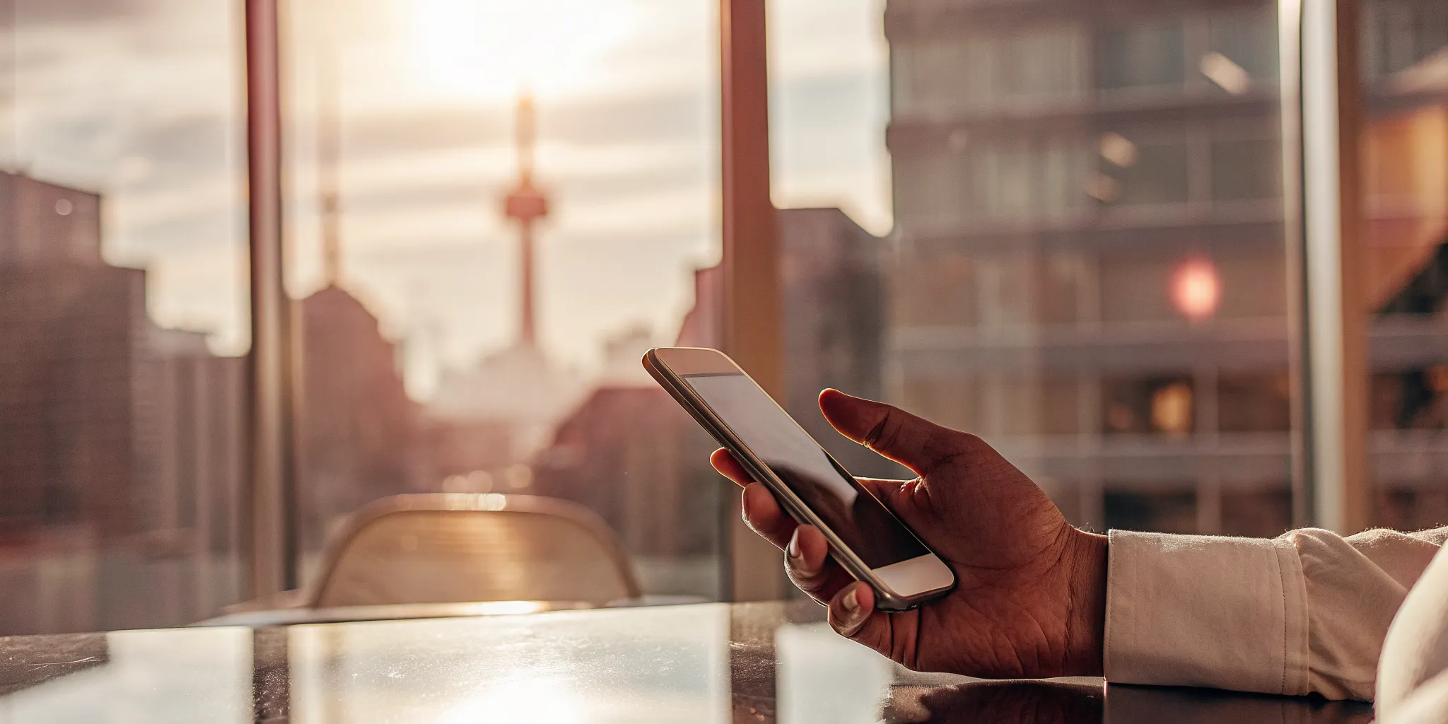 A person managing their finances using consumer-driven banking on a smartphone in Canada.