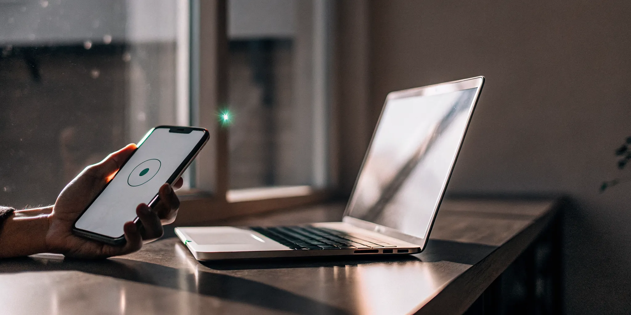 A person using a smartphone and laptop to apply for a fast e-transfer payday loan.