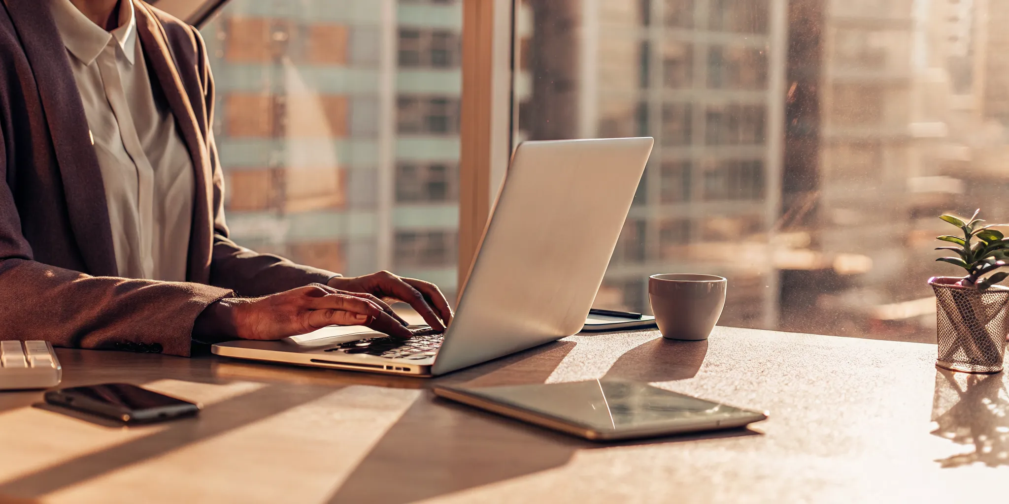 Person at a desk with a laptop, researching where to take out a loan.