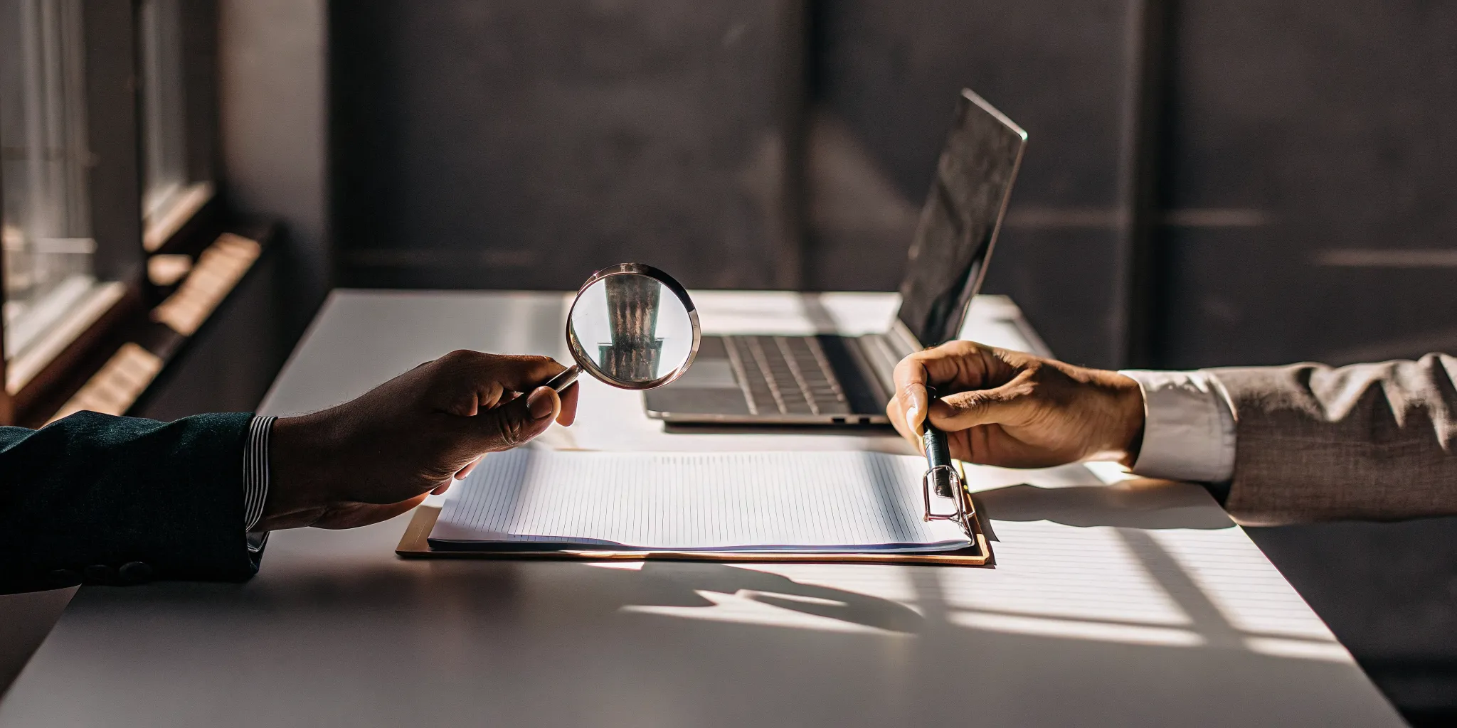 Two people review a loan agreement with a magnifying glass, questioning if no credit check loans are legitimate.