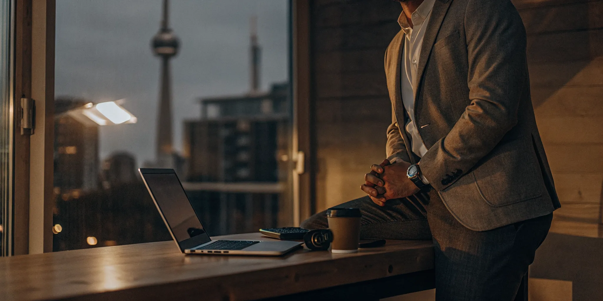 A self-employed borrower in Canada uses a laptop to apply for a loan.
