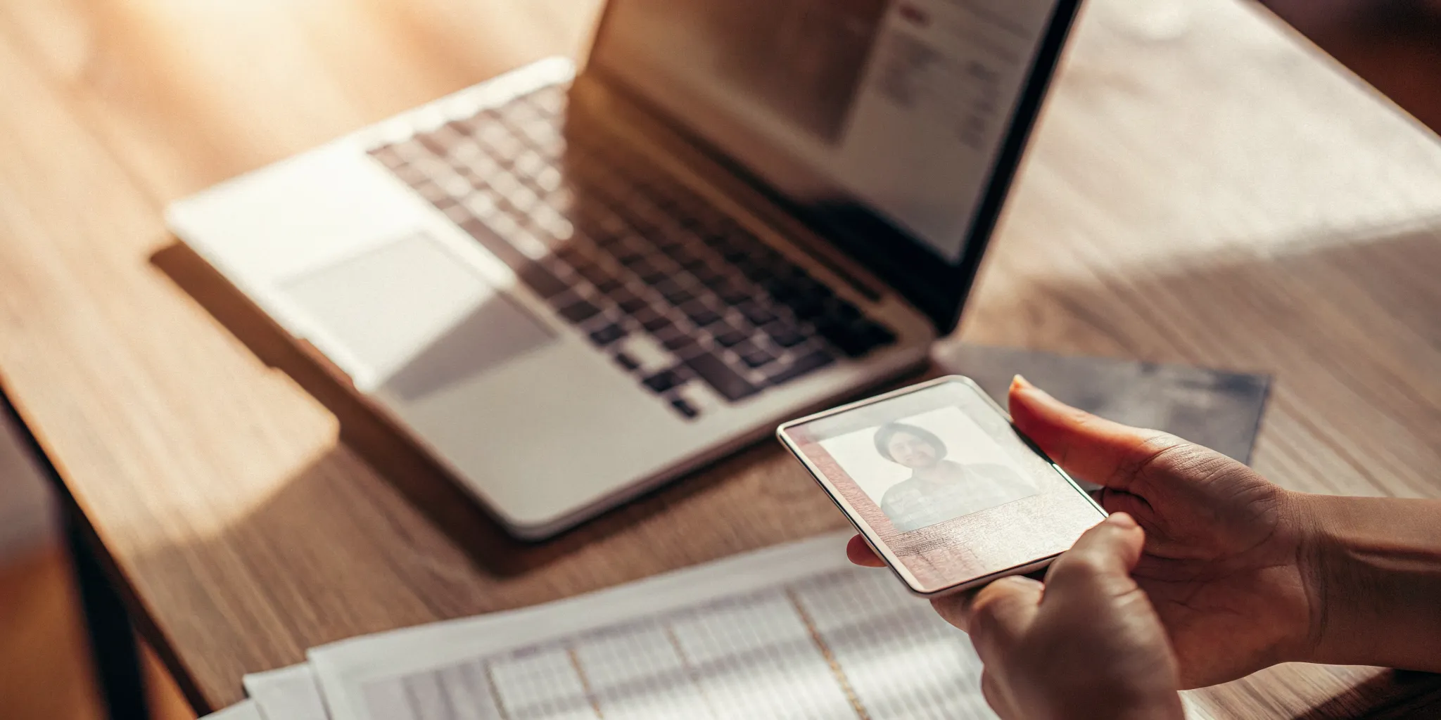A person holds an ID card, preparing the documents needed for an online payday loan.