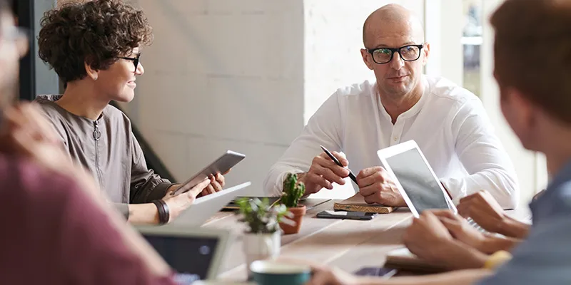 Colleagues reading tips on how to navigate seasonal fluctuations in business.
