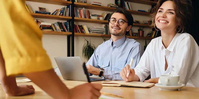 Small business owners reading 61 small business tips for growth.