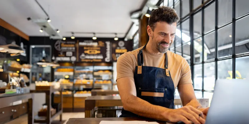 Bakery business owner smiling at doing less paperwork thanks to Bizcap's low-doc loans