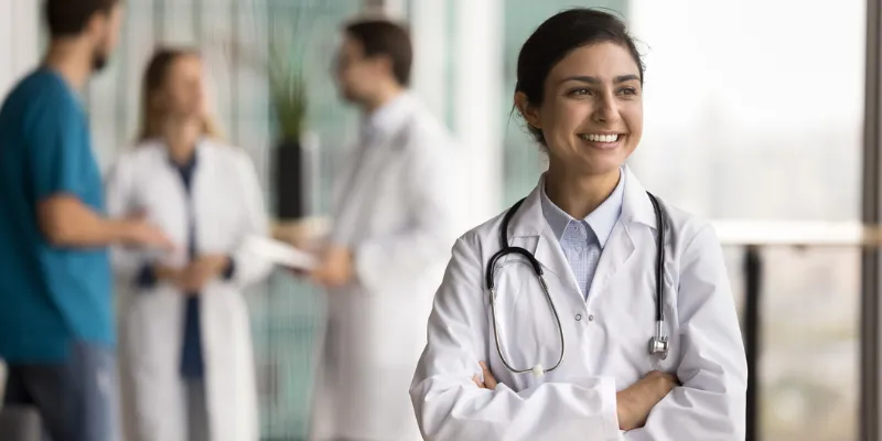 Women doctor smiling while working for a cosmetic healthcare brand in the UK