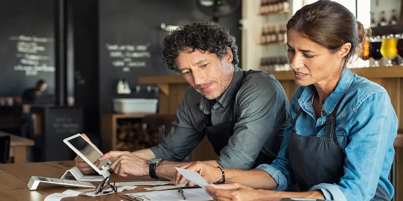 Two small business owners working out how much they can borrow