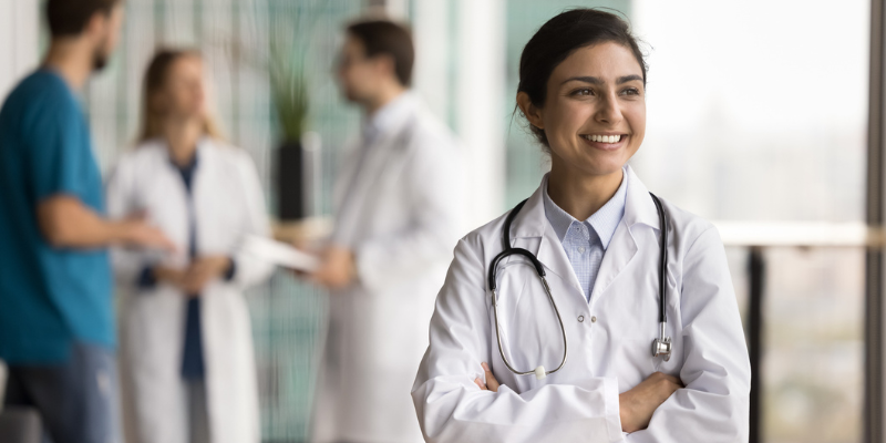 Women doctor smiling while working for a cosmetic healthcare brand in the UK