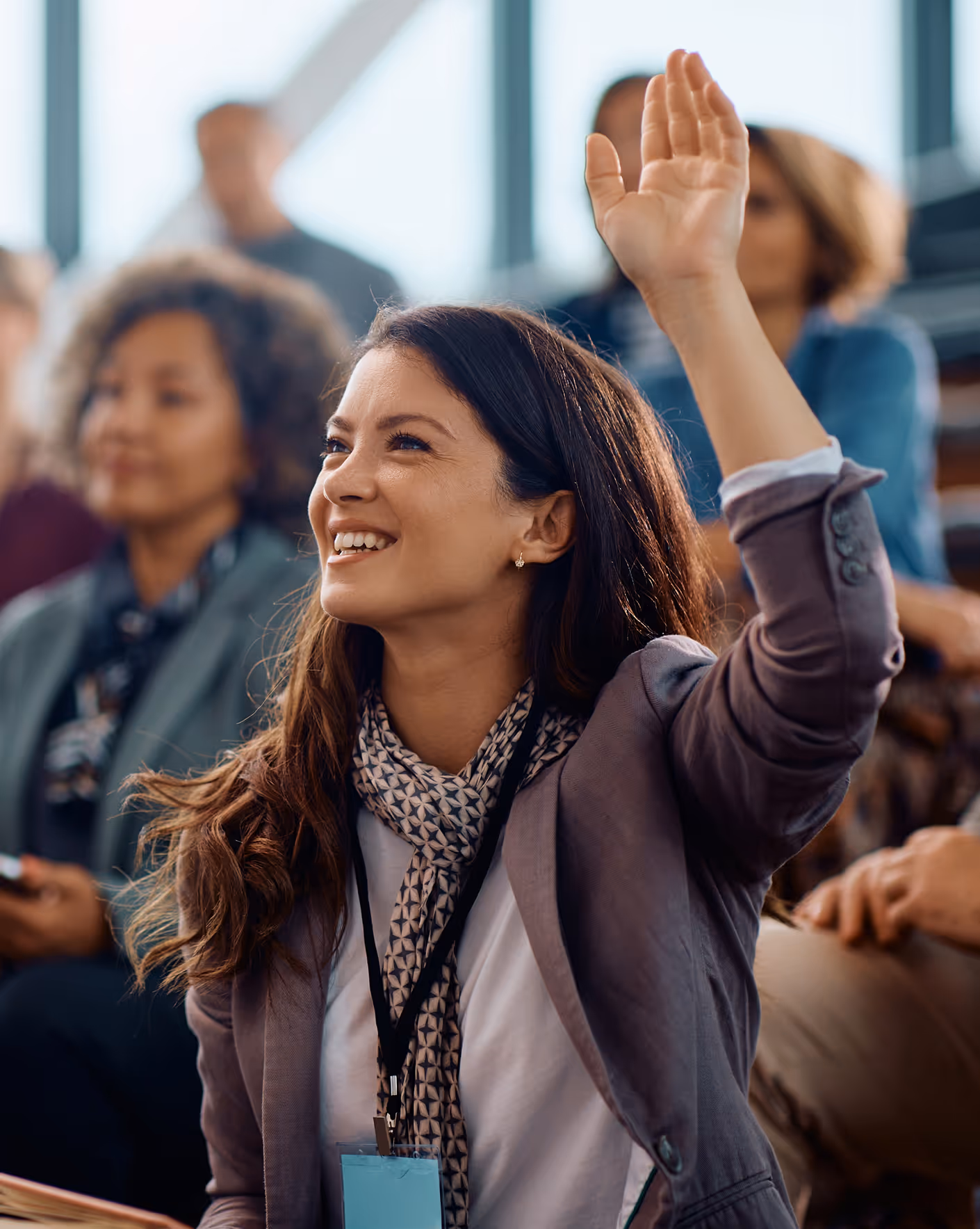 A woman from the audience is raising her hand