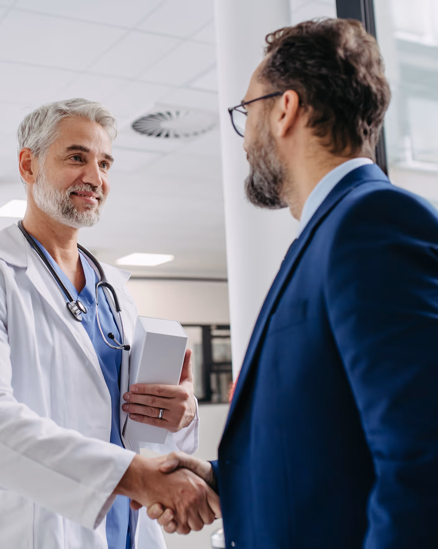An investigator is handshaking with a clinical trial sponsor