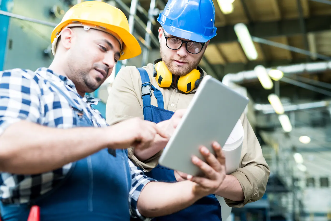 Maintenance technician and trainer reviewing interactive manuals on a tablet