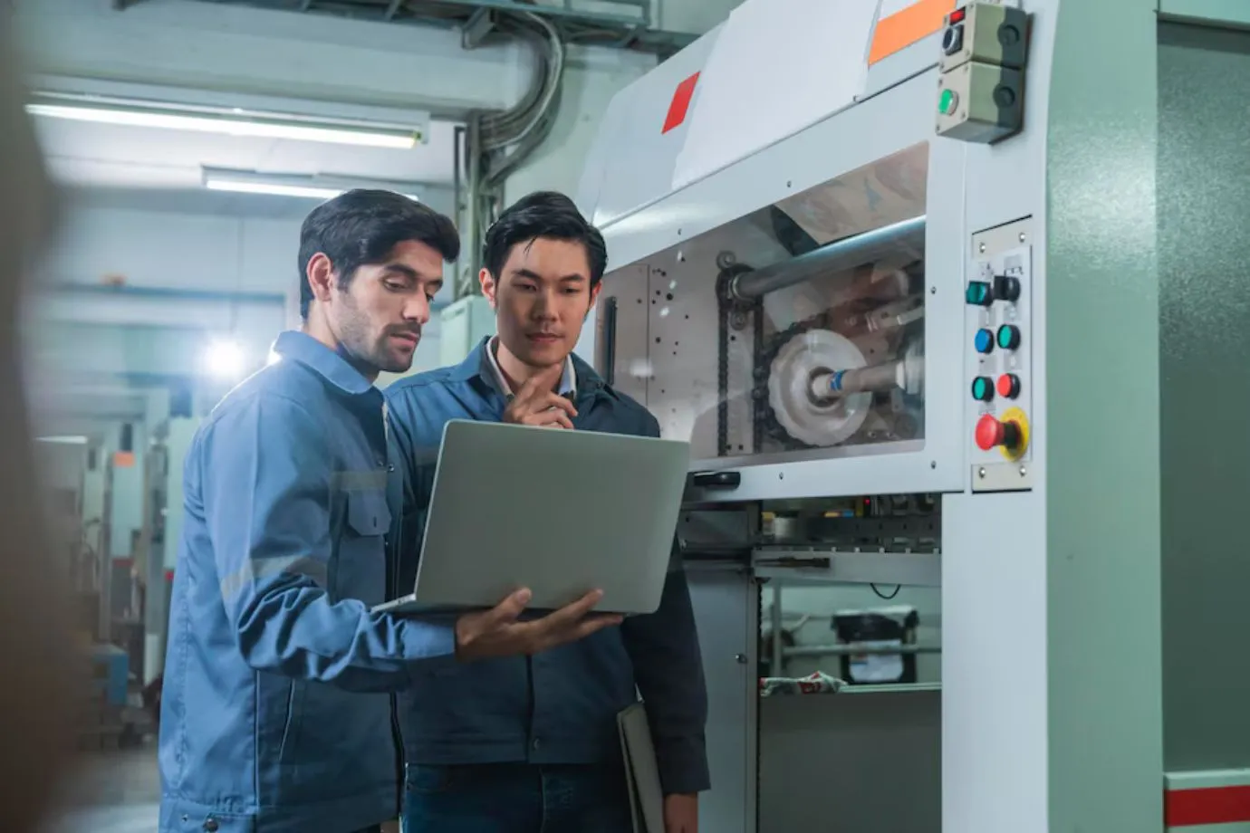 Technicians explore the key features of an interactive manual on a screen, highlighting tools like search functions, diagrams, and dynamic content