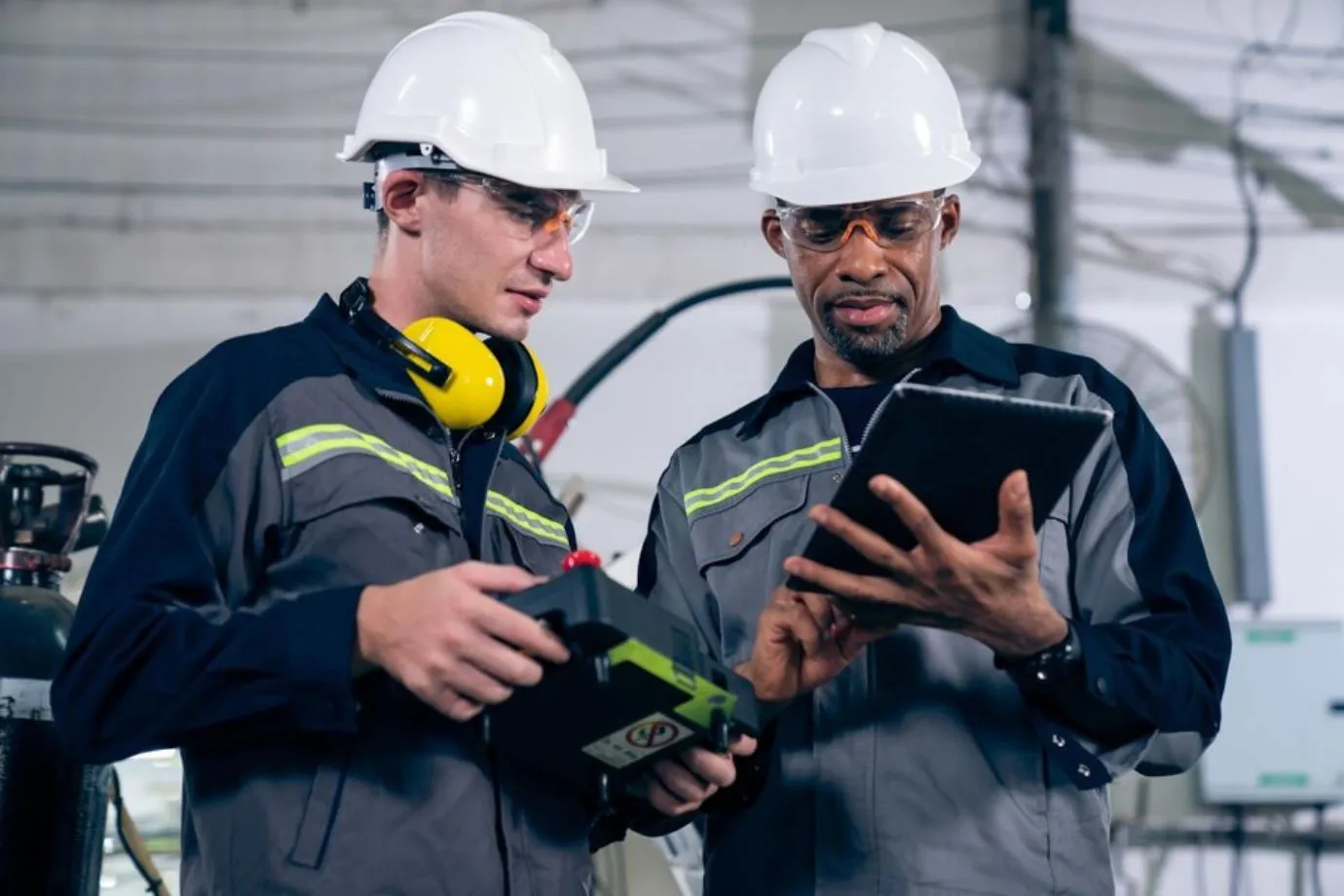 Technicians use an interactive repair manual on a screen