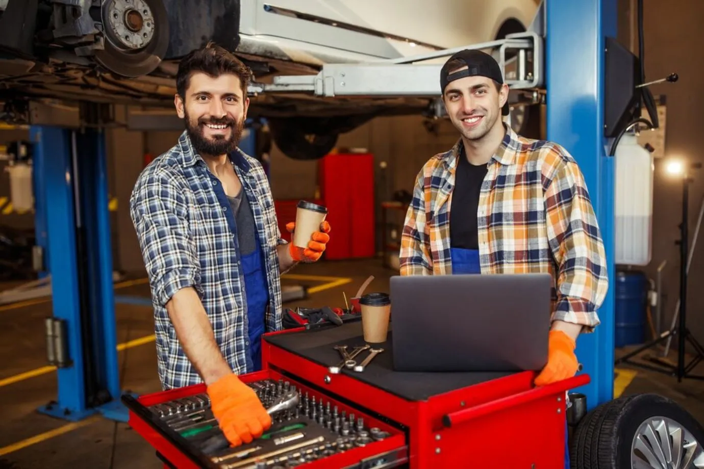 Technicians navigate digital repair manuals on a device, illustrating how digital tools boost productivity and streamline repair tasks
